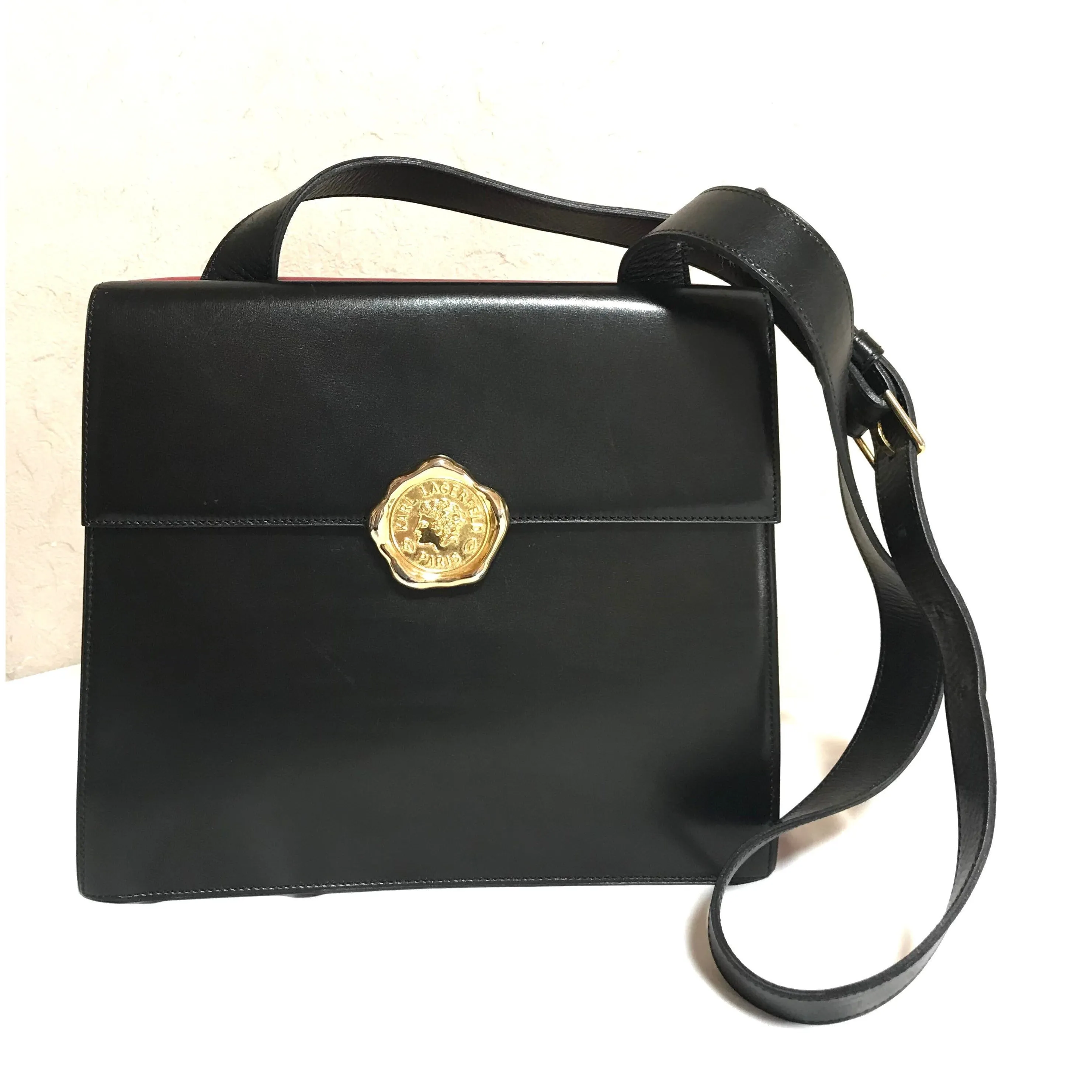 Vintage Karl Lagerfeld red and black double face shoulder bag with golden logo motifs. Rare unique bag. Must have.